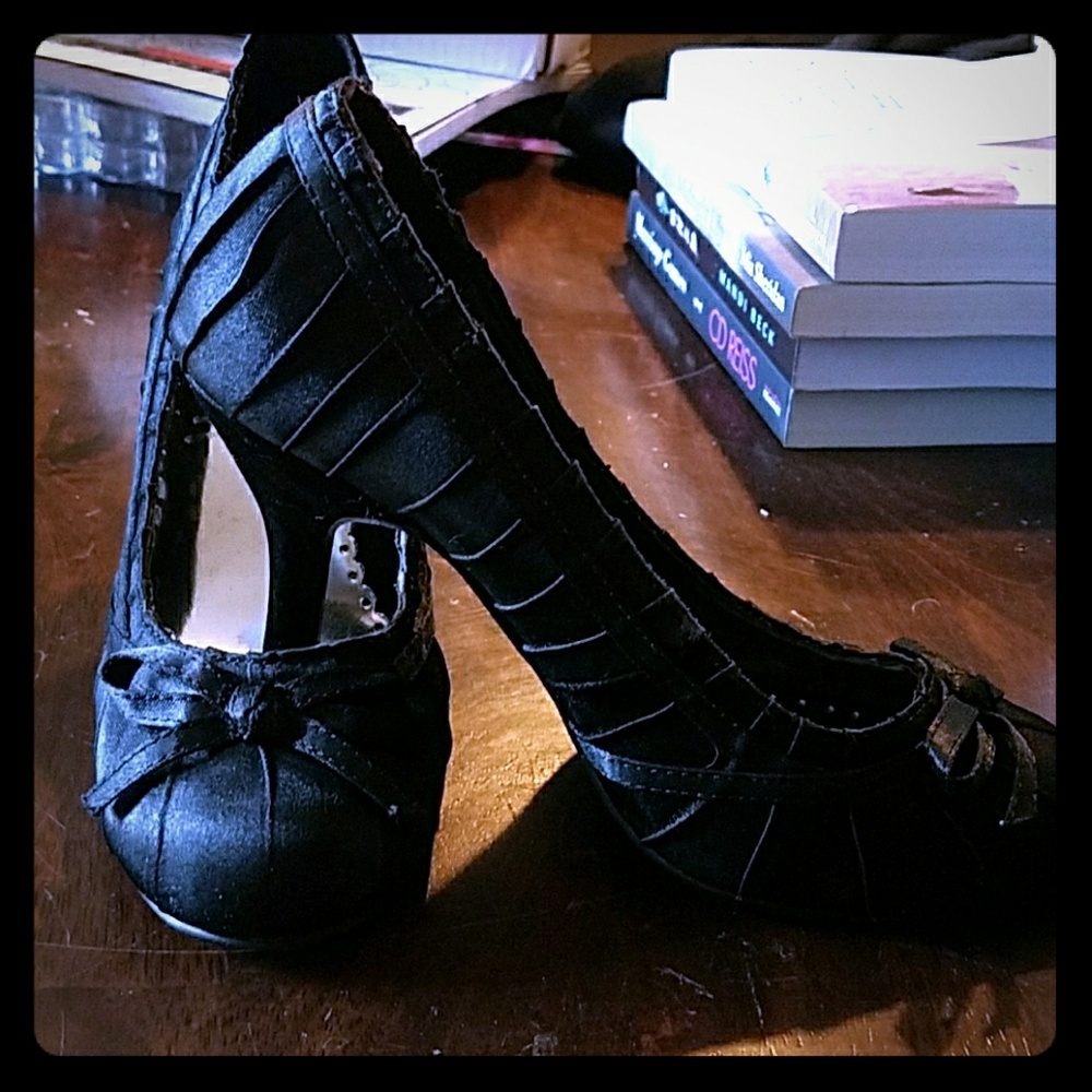 Black heels, size 7, with bow on top.